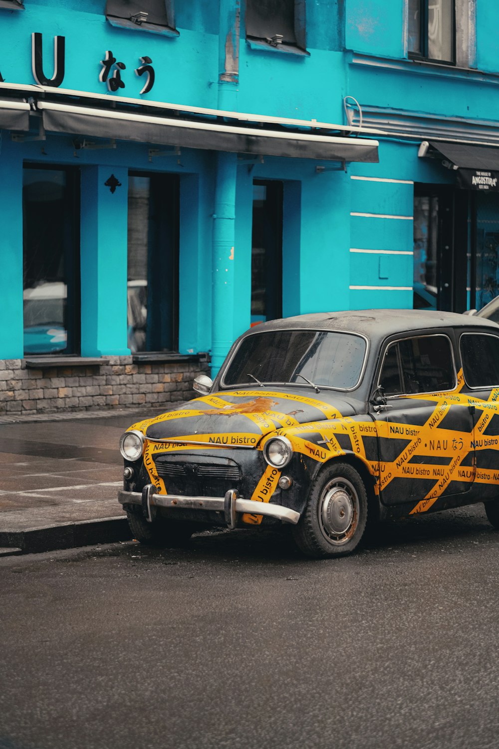 a yellow and black taxi parked on the side of the road