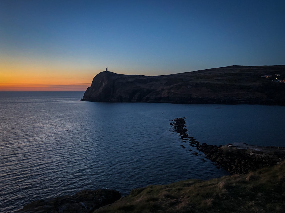 the sun is setting over a body of water