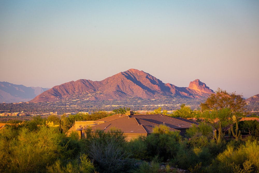 a view of a mountain range with a house in the foreground