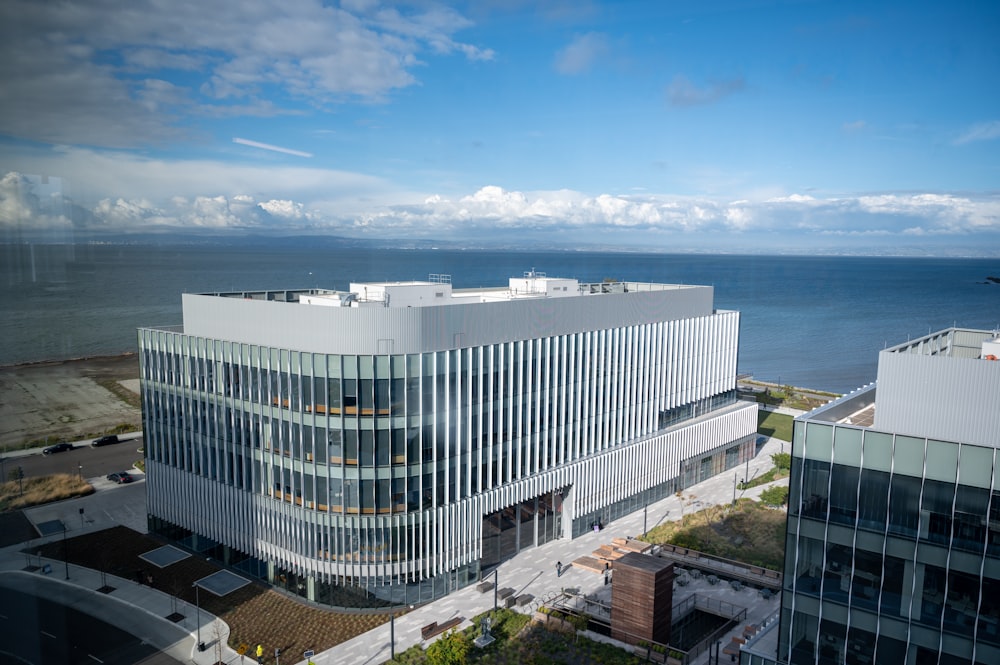 an aerial view of a large building next to a body of water