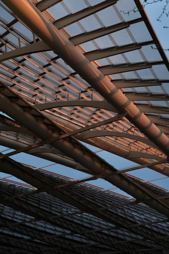 a close up of a metal structure with a sky background