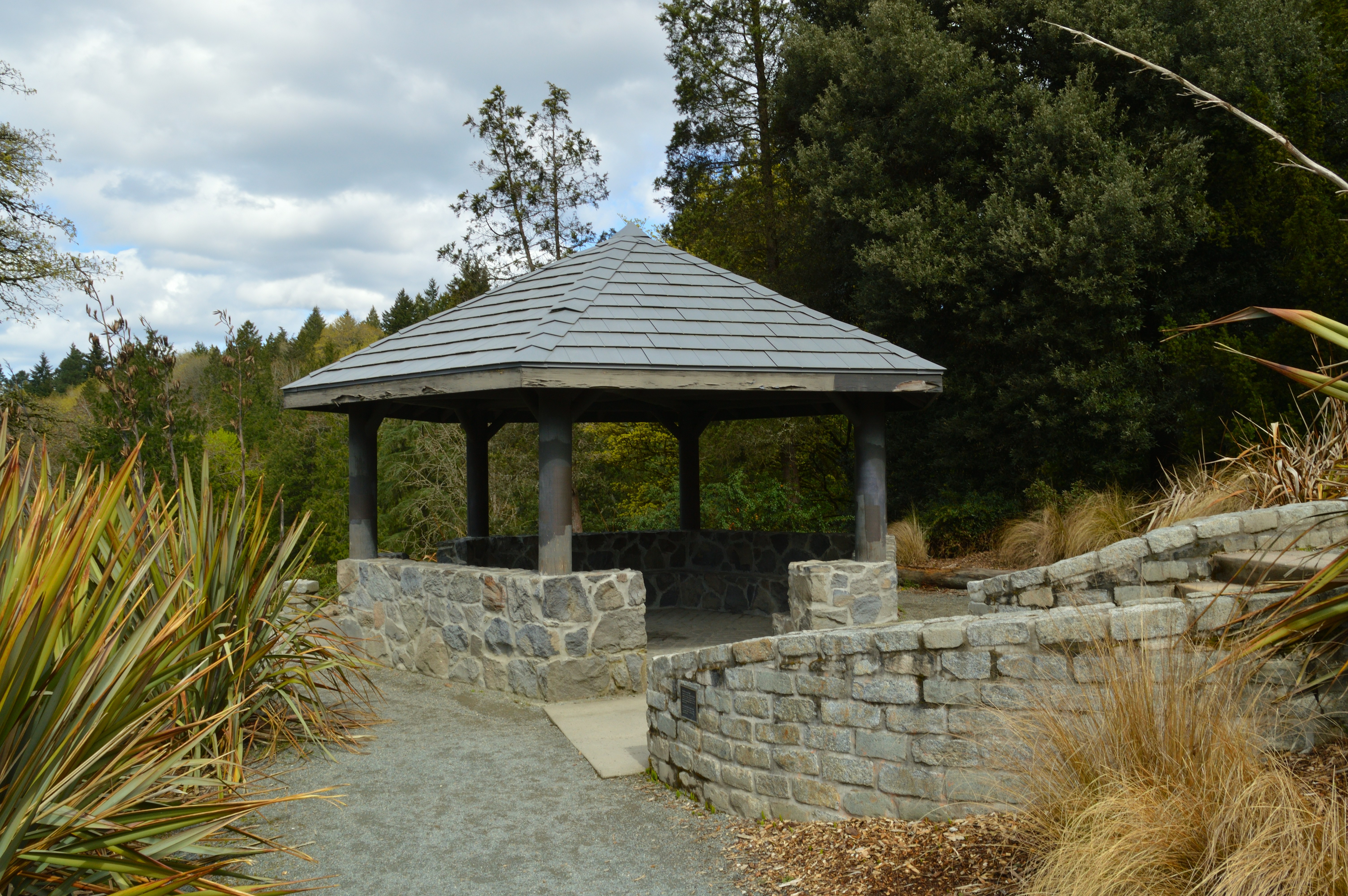 a gazebo in the middle of a stone wall