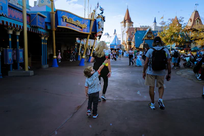 a small child is walking in front of a crowd of people