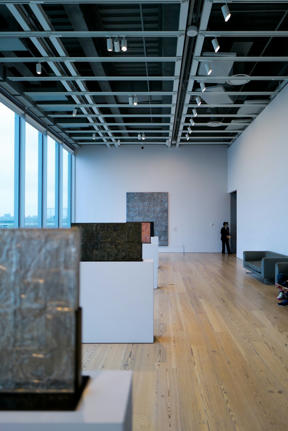 a person standing in a large room with wooden floors