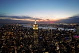 A panoramic view of a bustling city skyline at sunset.