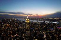 A panoramic view of a bustling Egyptian city skyline at sunset with residential buildings.