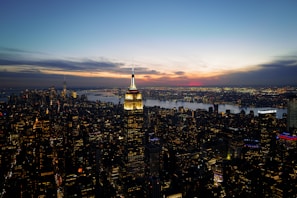 A panoramic cityscape view at sunset with illuminated skyscrapers