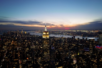 A panoramic cityscape view at sunset with illuminated skyscrapers
