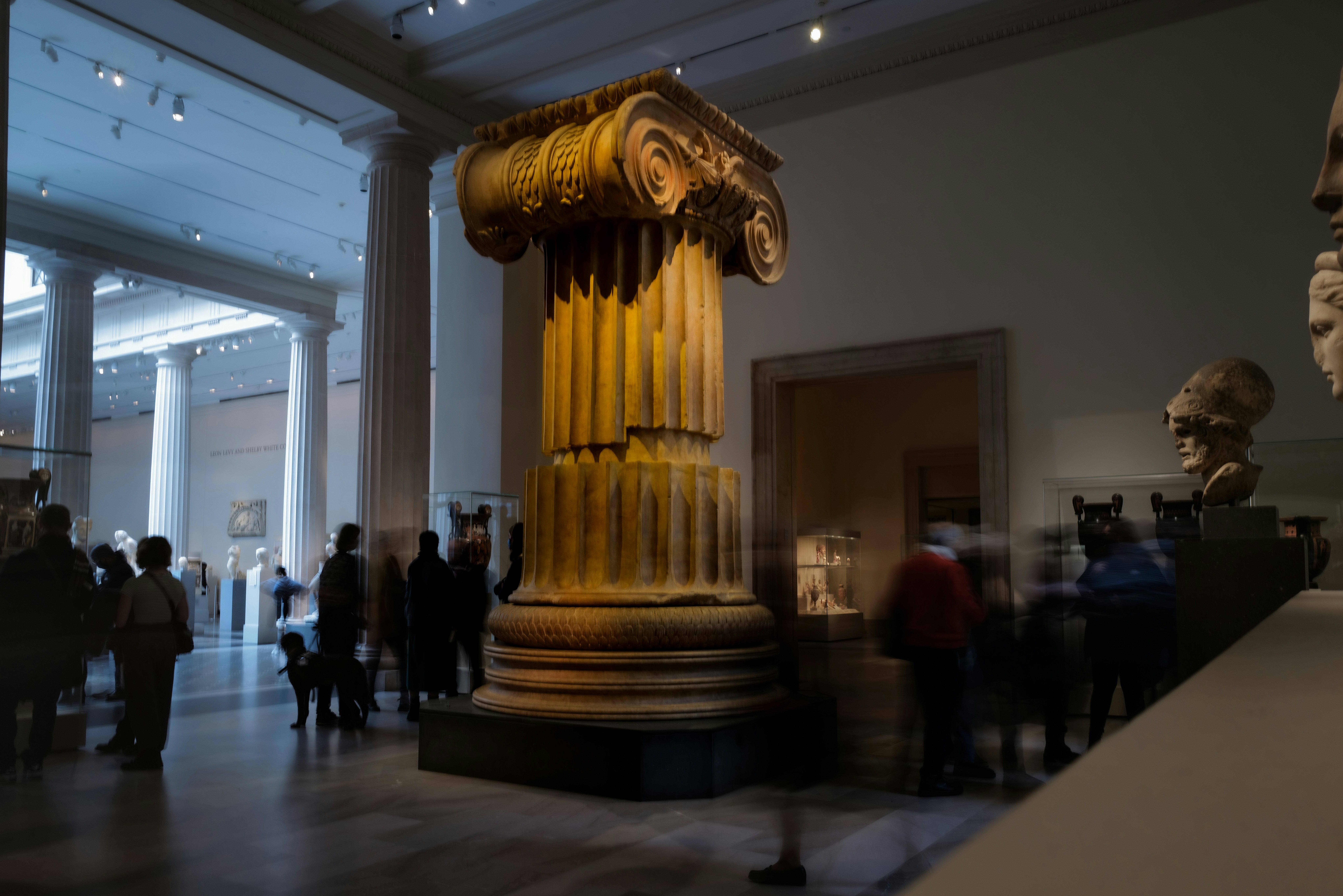 a group of people standing around in a museum