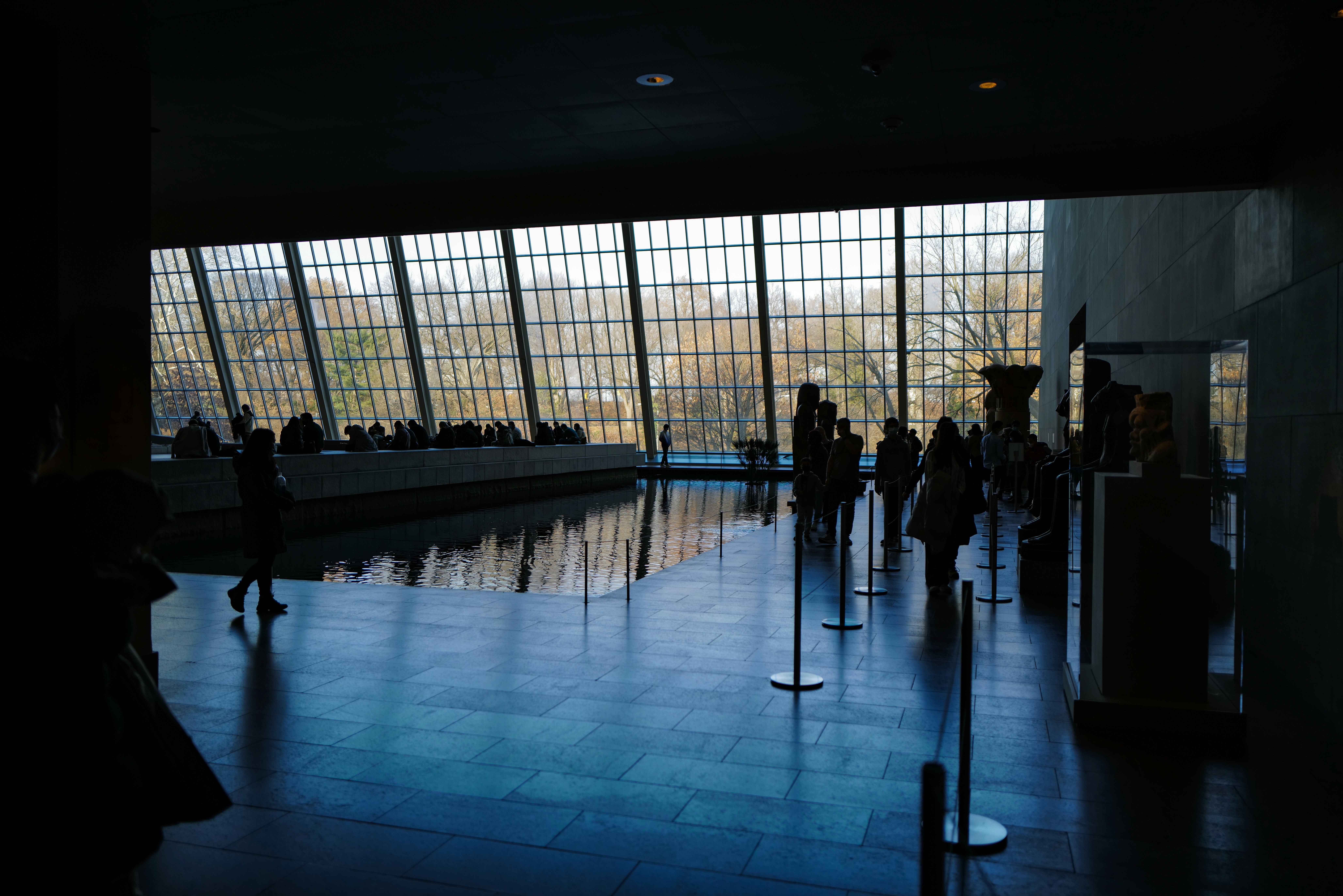a group of people standing in front of a large window