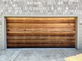 a wooden garage door on a brick building