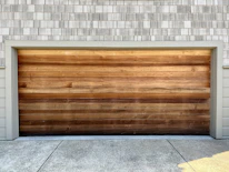 a wooden garage door on a brick building
