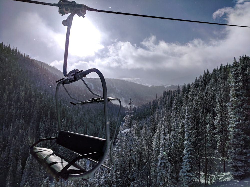 a ski lift going up a snowy mountain