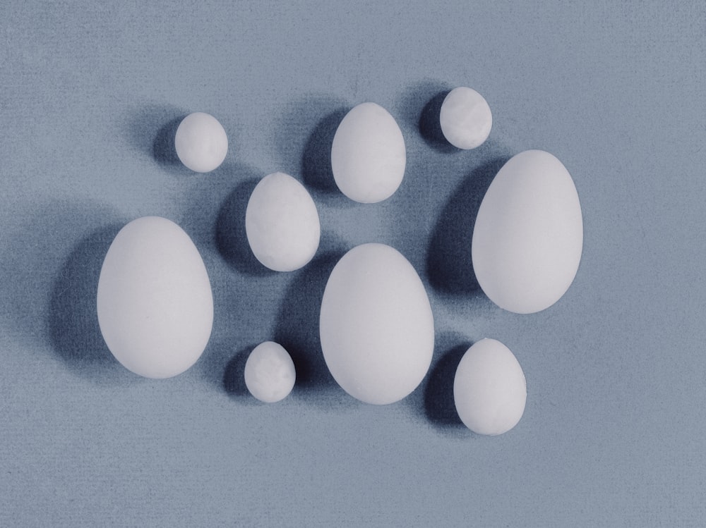a group of eggs sitting on top of a blue surface