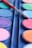 Close-up of a vibrant paint palette and brushes on a table during a painting party.