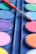 Close-up of a vibrant paint palette and brushes on a table during a painting party.