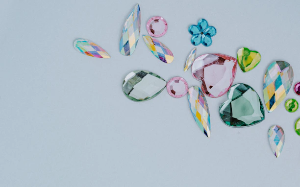 Close-up of sparkling raw gemstones in various colors ready for jewelry crafting.