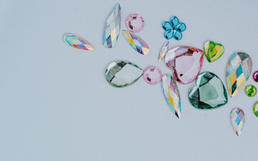 a group of different colored stones on a white surface