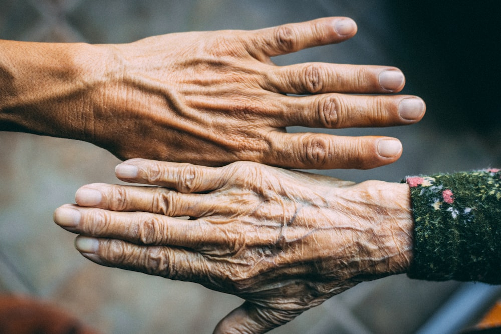 a close up of two hands holding each other