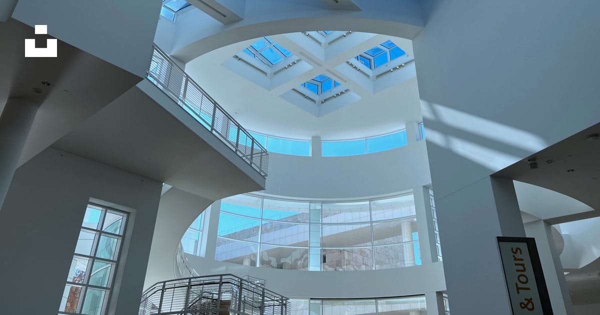 A large atrium with a skylight and a spiral staircase photo – Free ...