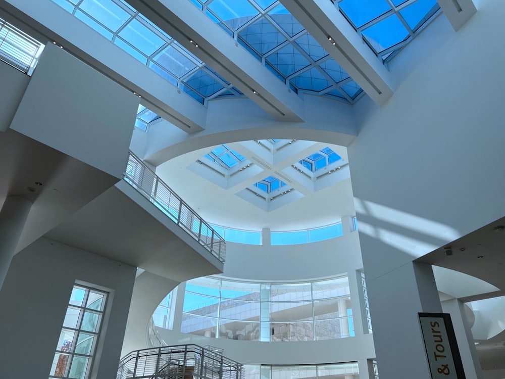 a large atrium with a skylight and a spiral staircase