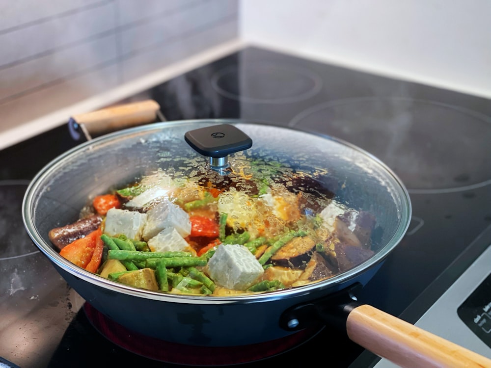 a pan of food cooking on a stove top