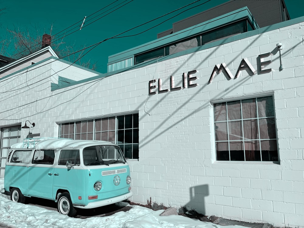 a blue and white van parked in front of a building