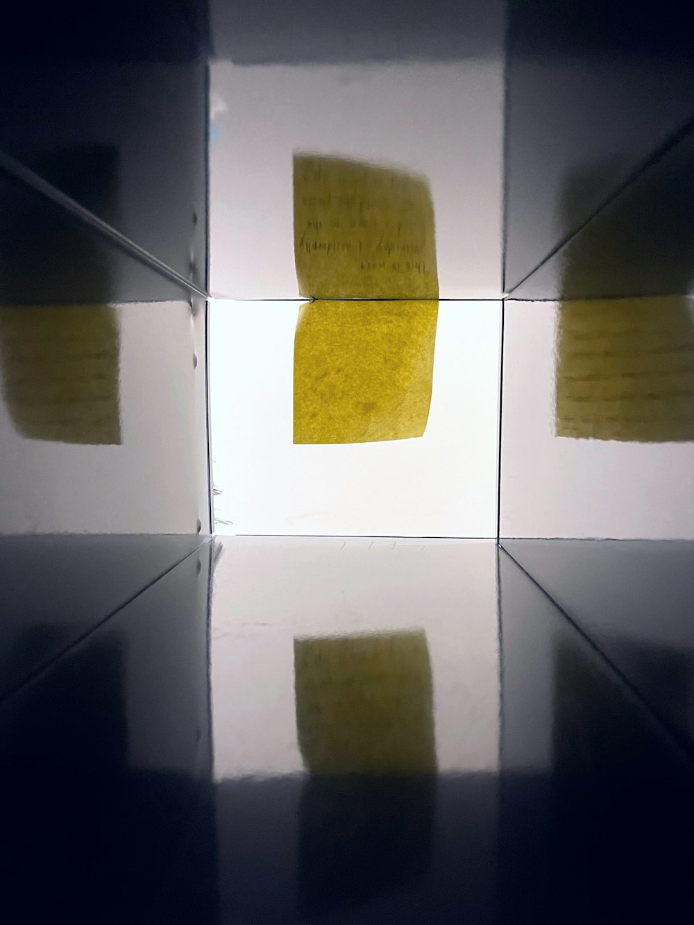 a yellow piece of paper sitting on top of a table