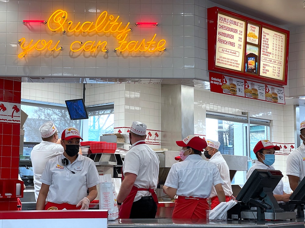 a group of people standing in line at a fast food restaurant