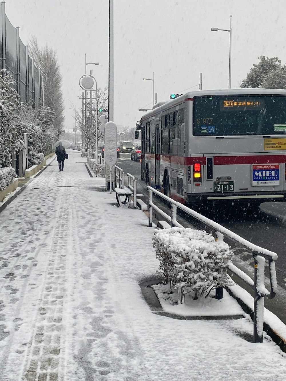 a bus driving down a snow covered street