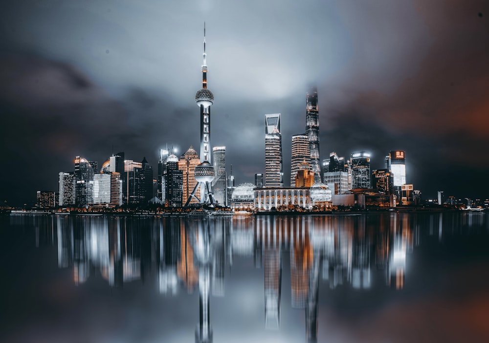 a picture of a city at night with a reflection in the water