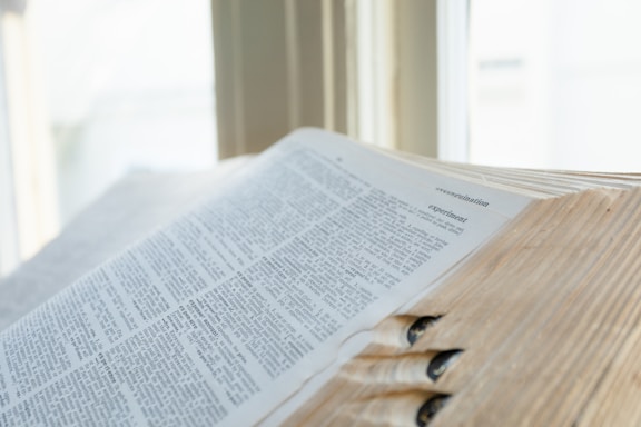 an open book sitting on top of a wooden table