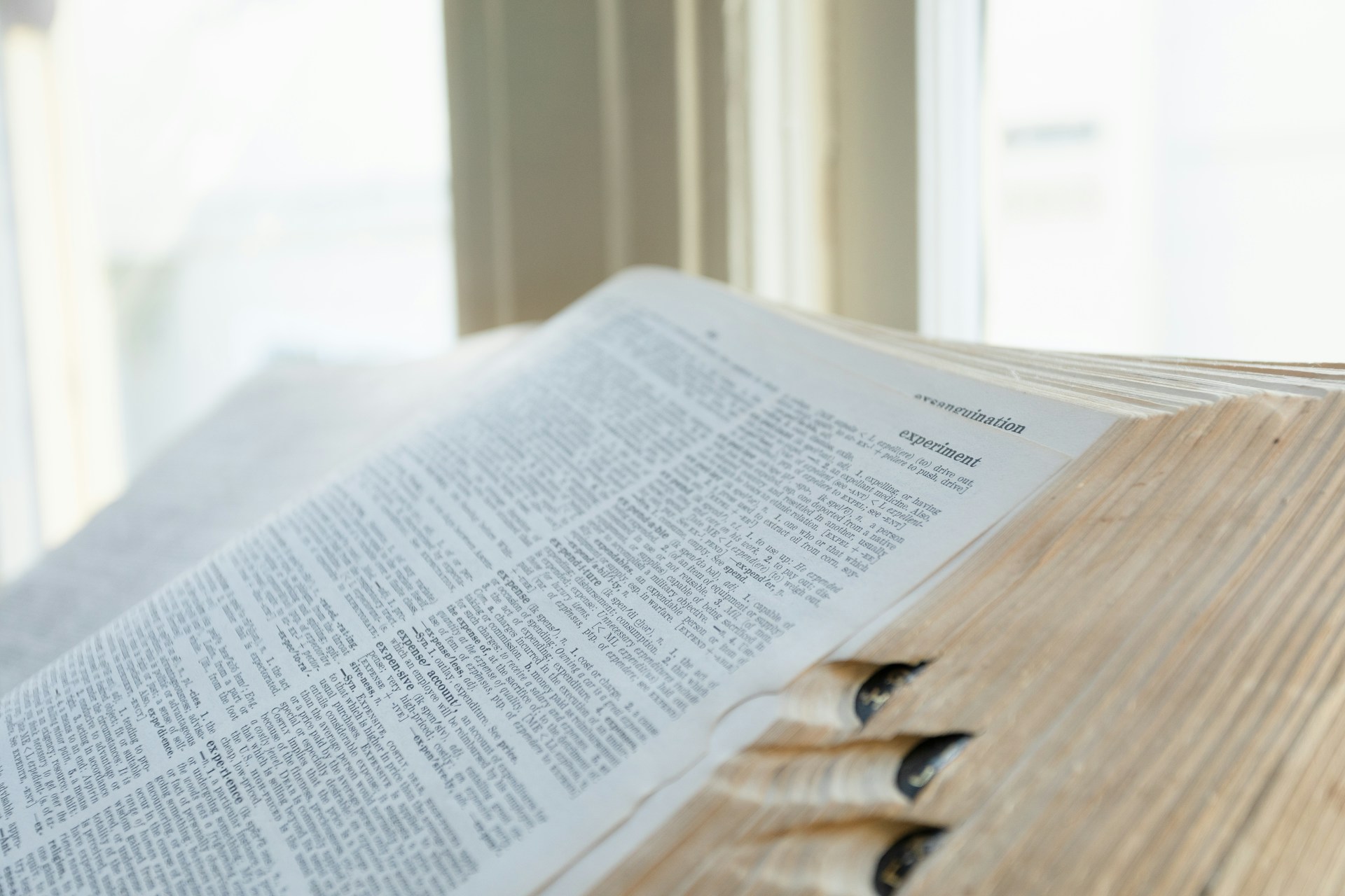 an open book sitting on top of a wooden table