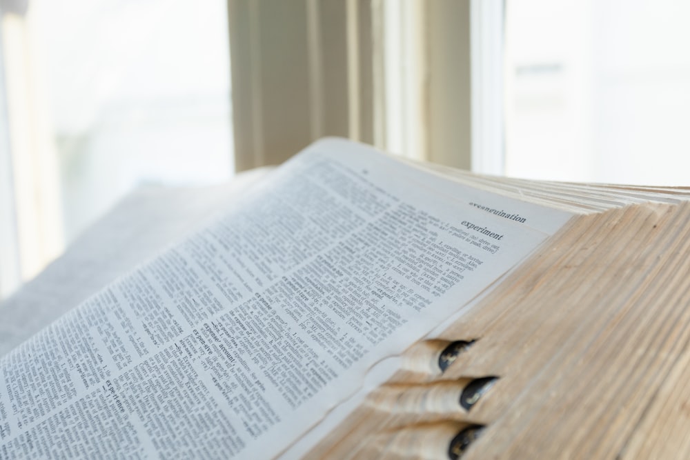 an open book sitting on top of a wooden table