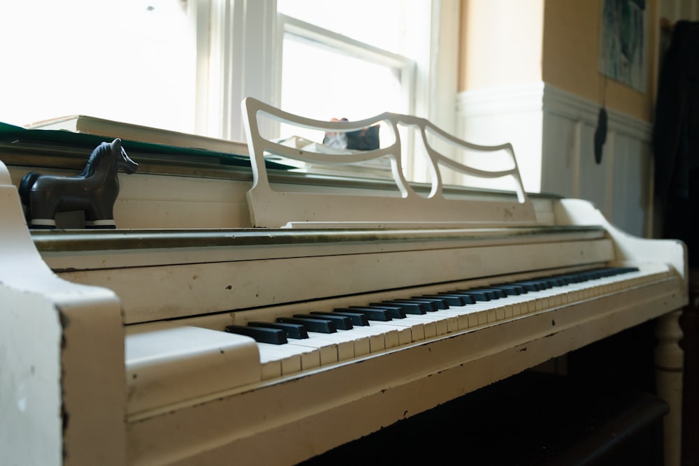 a toy horse sitting on top of a piano