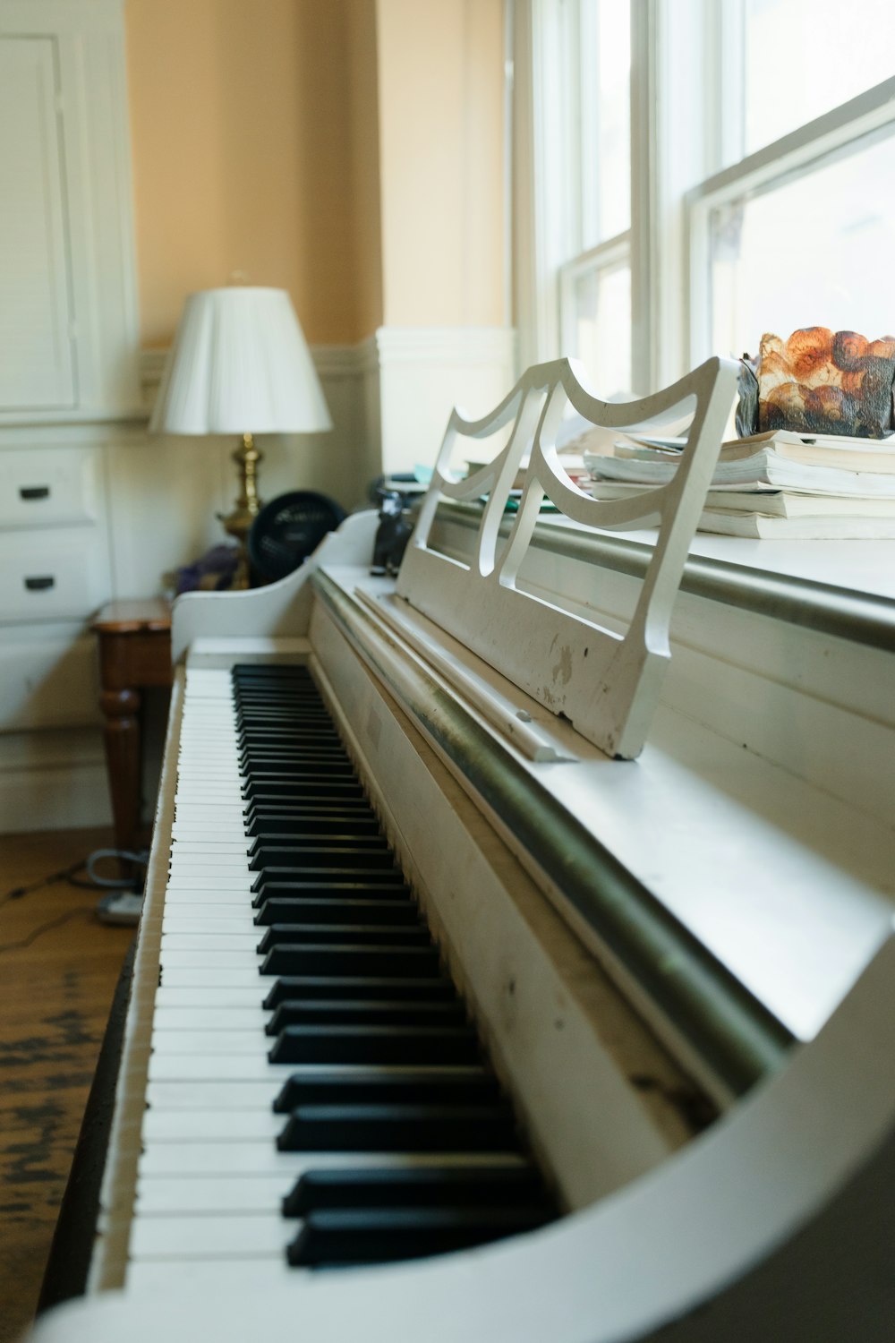 a close up of a piano near a window