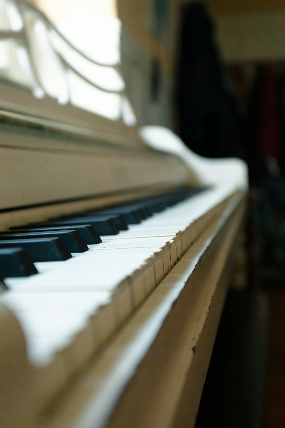 a close up of a piano keyboard with a blurry background