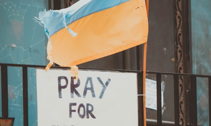 a sign that says pray for ukraine