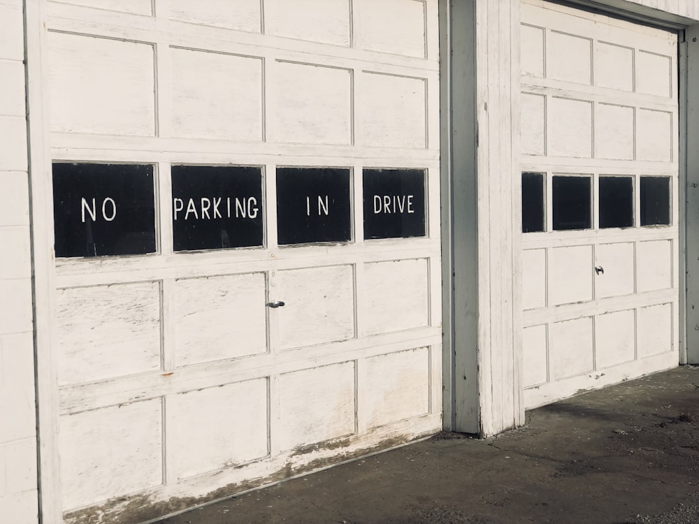 two garage doors with no parking signs on them