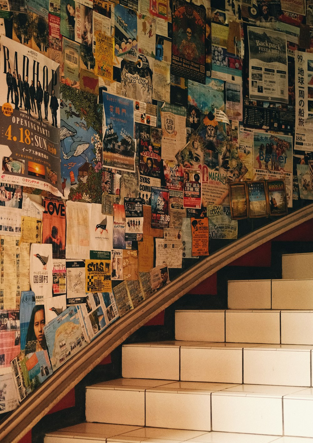 a bunch of newspapers are on the wall next to the stairs
