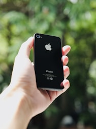 a person holding an iphone in their hand