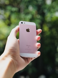 Compact iPhone SE (3rd gen) shown with a colorful background emphasizing portability.