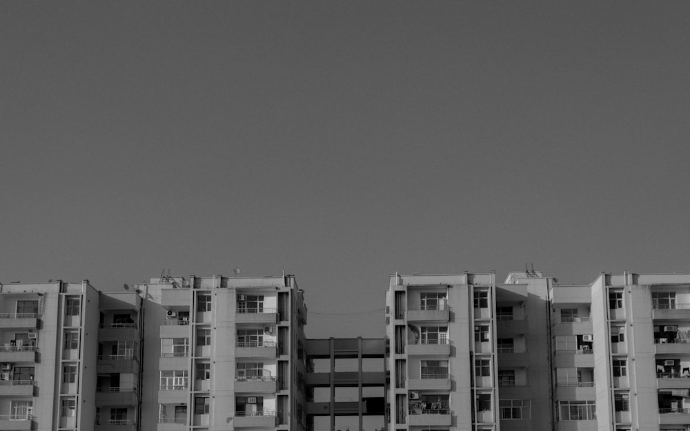 a black and white photo of a building with balconies