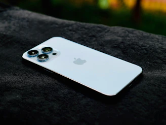 a close up of an iphone on a black surface
