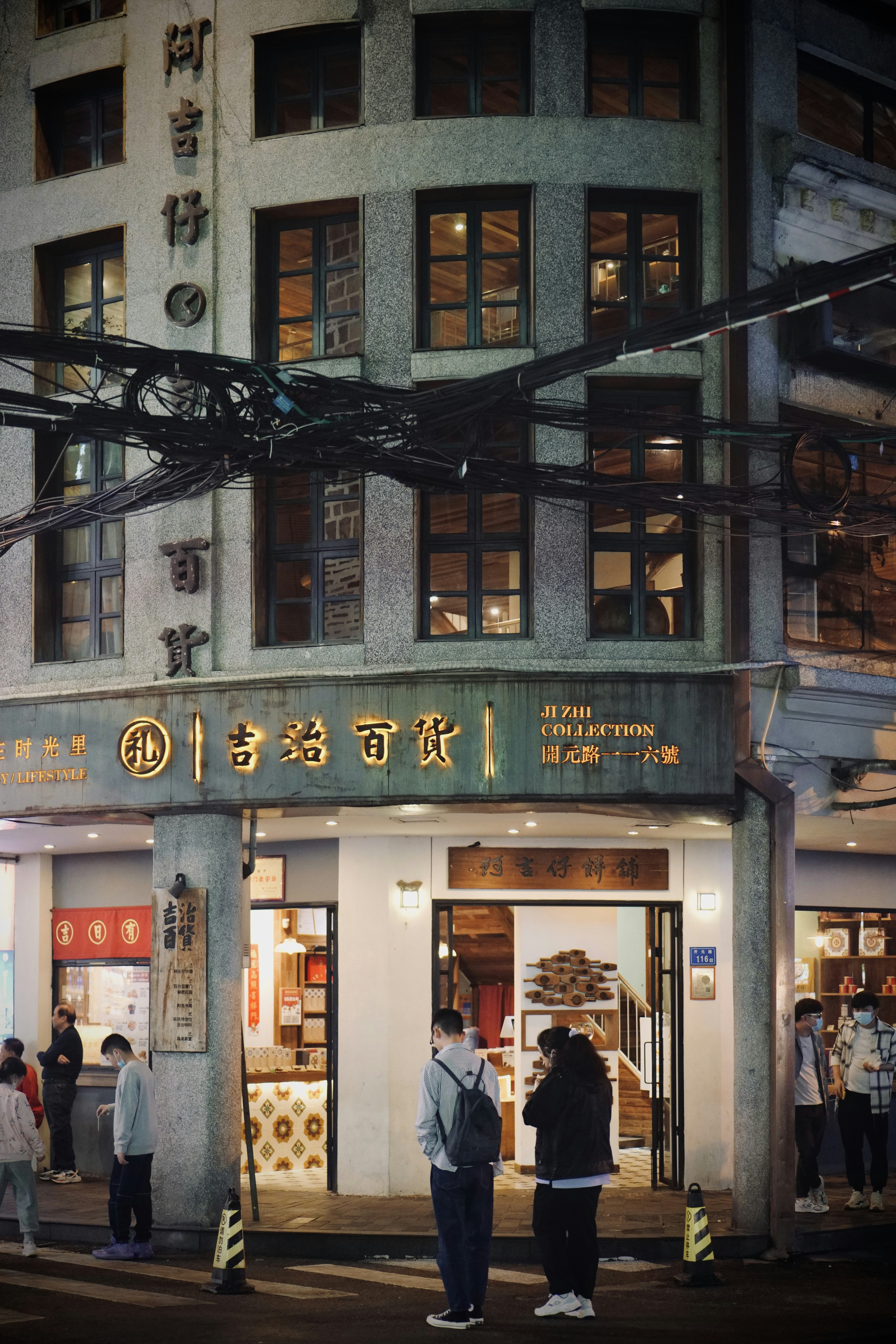 a group of people standing outside of a building