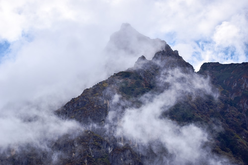 a very tall mountain covered in fog and clouds