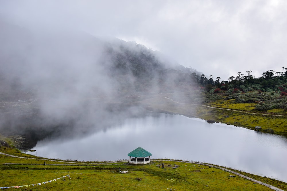 a lake surrounded by a lush green hillside