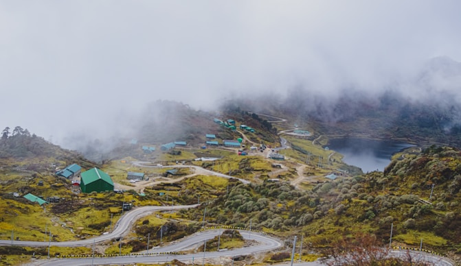 a scenic view of a winding road in the mountains