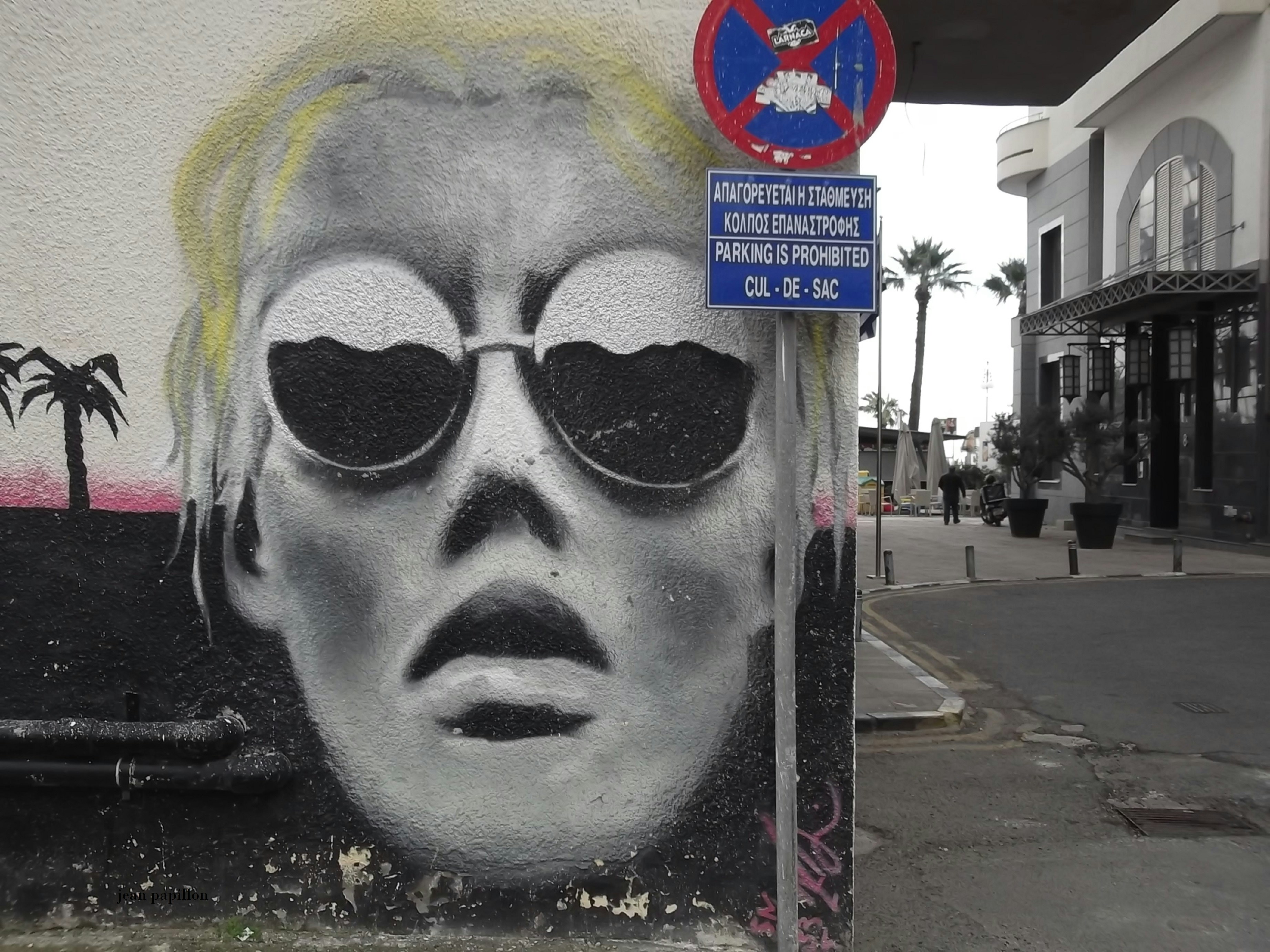 a painting of a woman with sunglasses on a street corner