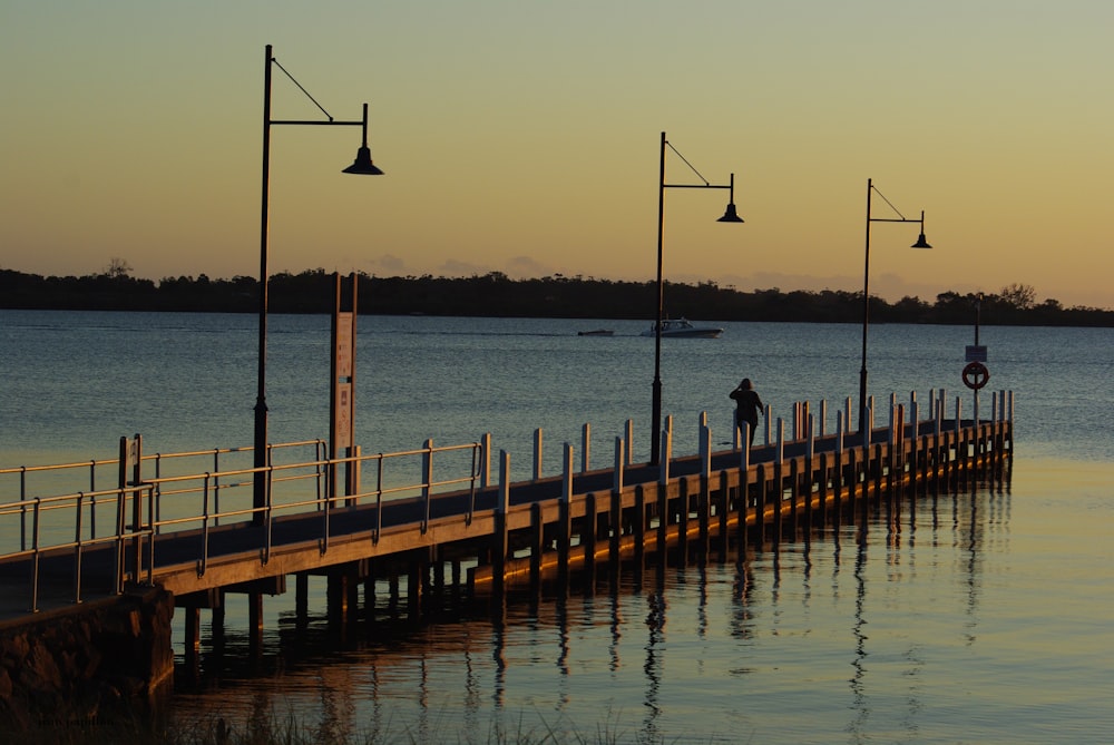 a pier with a few people standing on it